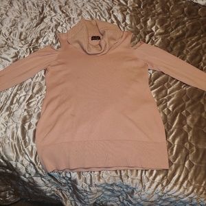 Pink sweater with gold accents, shoulder showing